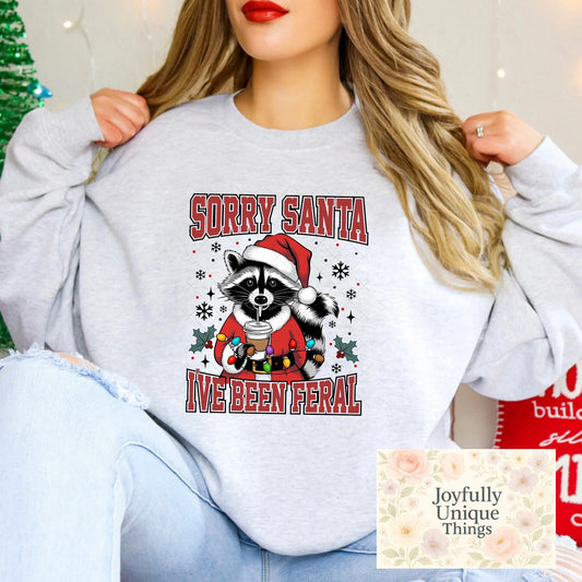 Short Sleeve T-Shirt Christmas Lights Santa Suit Raccoon Trash Panda Drinking Coffee Sorry Santa I've Been Feral