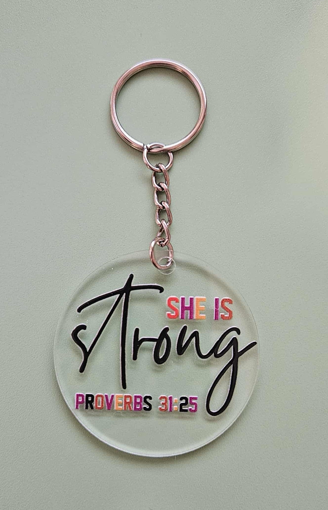 Clear Acrylic 2.5" Round Keychain With UV DTF Sticker She Is Strong Proverbs 31:25 - Joyfully Unique Things